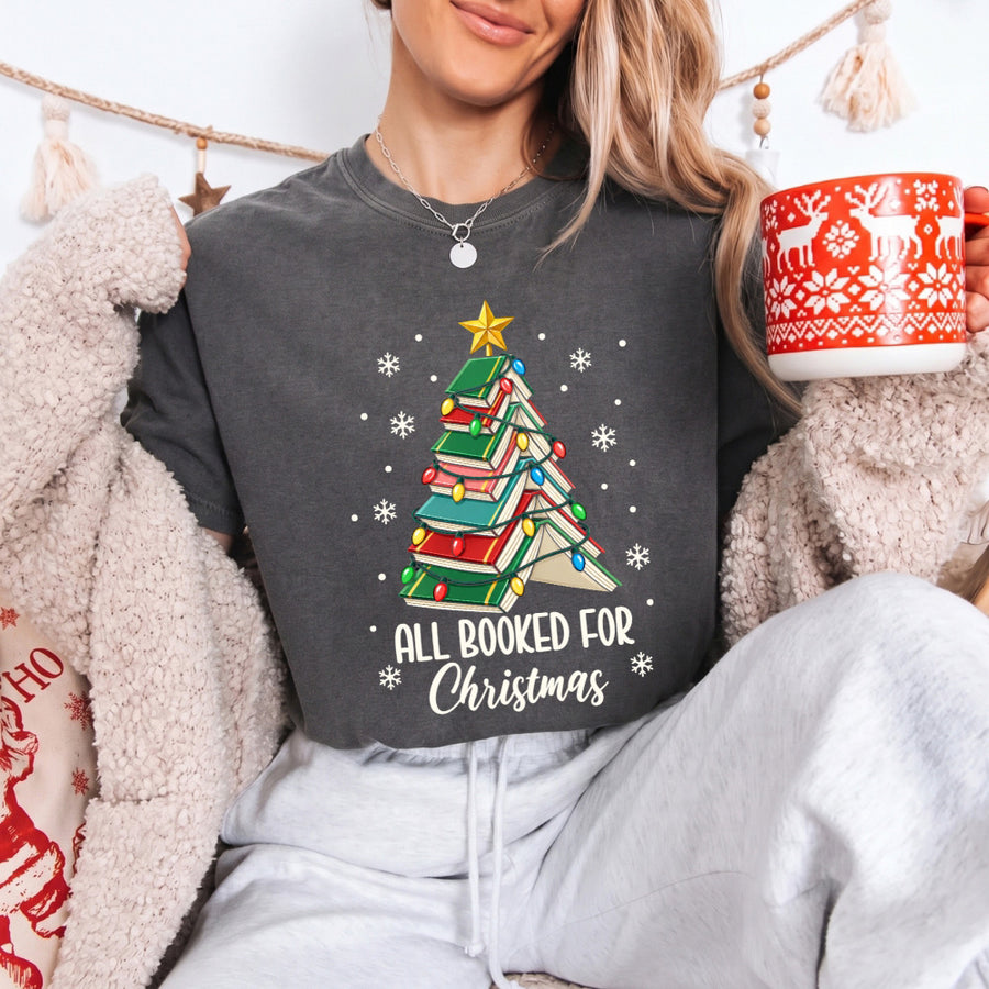 May include an All Booked for Christmas Book Lover Comfort Colors T-Shirt featuring a festive Christmas and reading-inspired design.