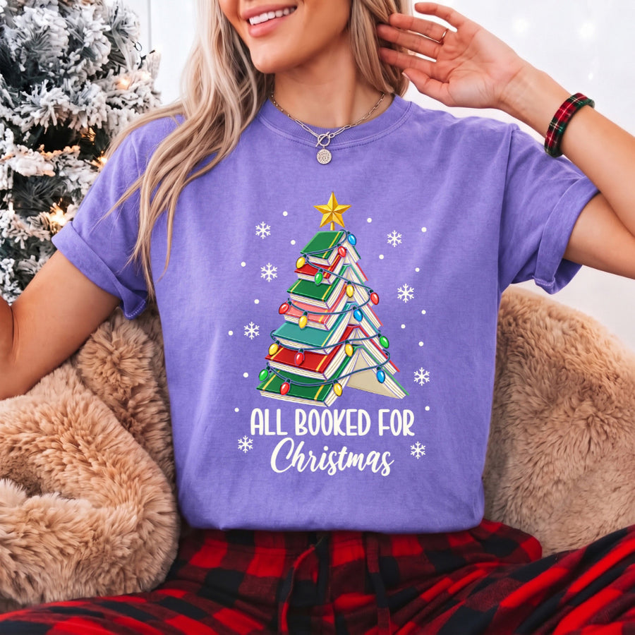 May include an All Booked for Christmas Book Lover Comfort Colors T-Shirt featuring a festive Christmas and reading-inspired design.
