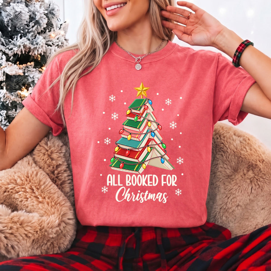 May include an All Booked for Christmas Book Lover Comfort Colors T-Shirt featuring a festive Christmas and reading-inspired design.
