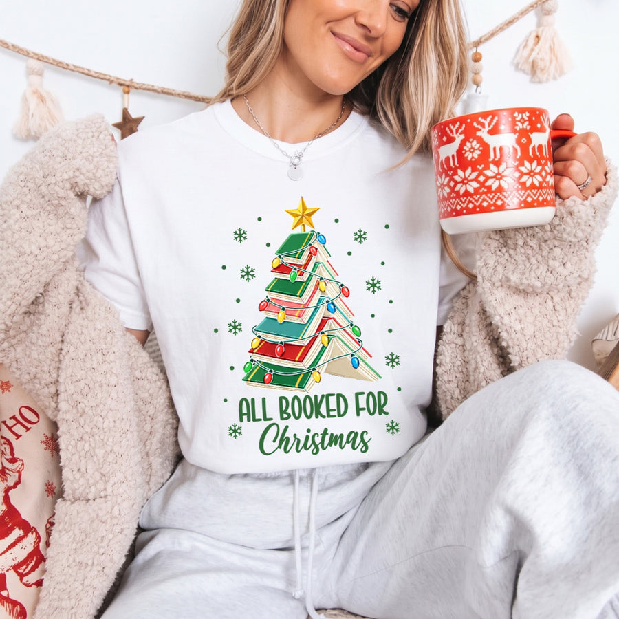 May include an All Booked for Christmas Book Lover Comfort Colors T-Shirt featuring a festive Christmas and reading-inspired design.