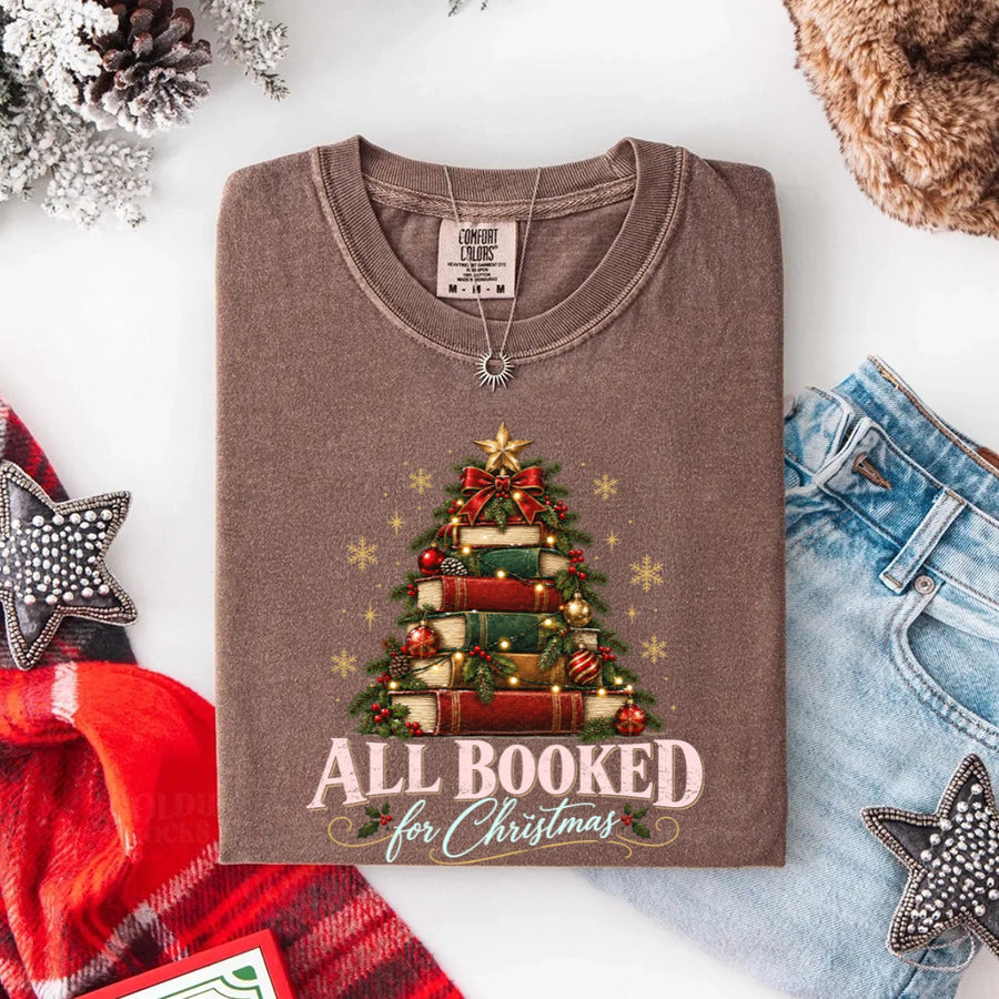 May include an All Booked for Christmas Comfort Colors T-Shirt featuring a festive book lover statement design.