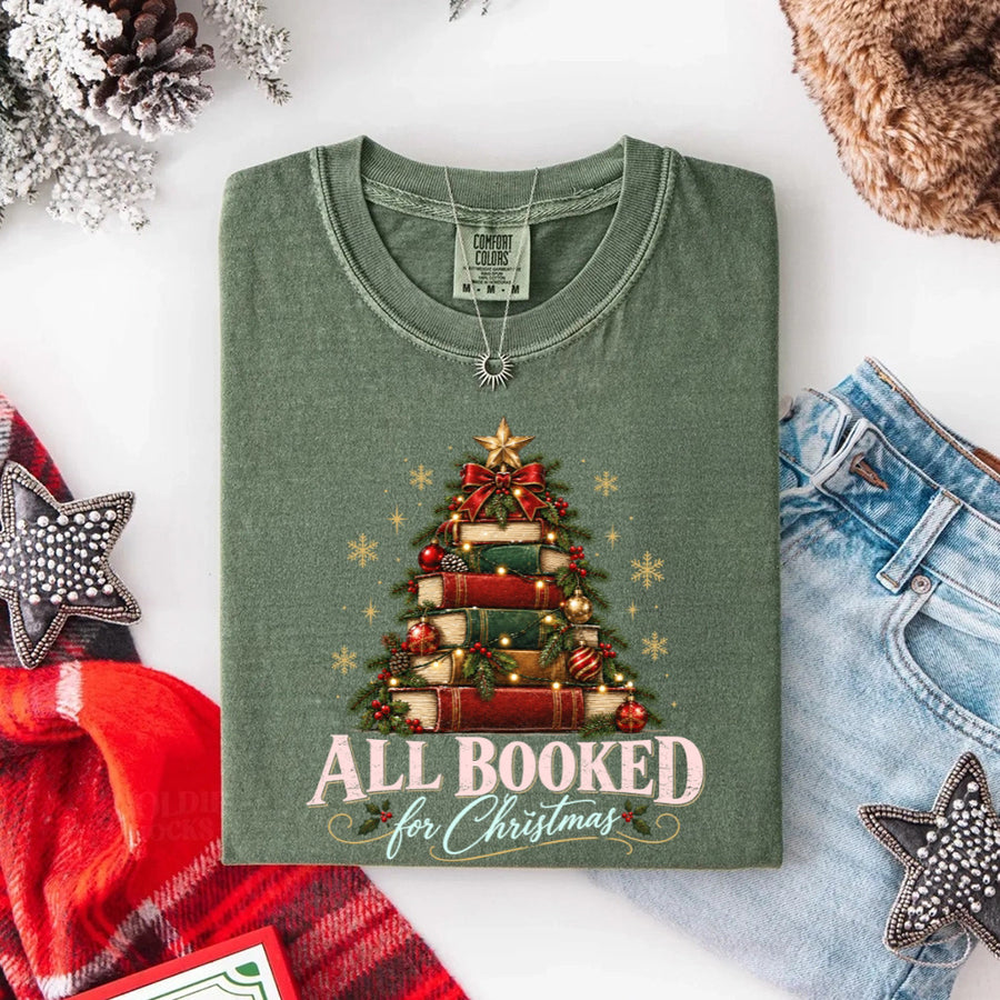 May include an All Booked for Christmas Comfort Colors T-Shirt featuring a festive book lover statement design.