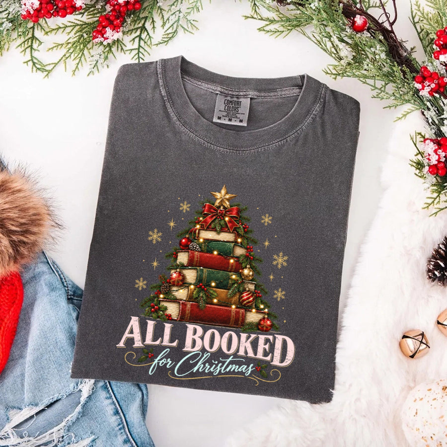 May include an All Booked for Christmas Comfort Colors T-Shirt featuring a festive book lover statement design.