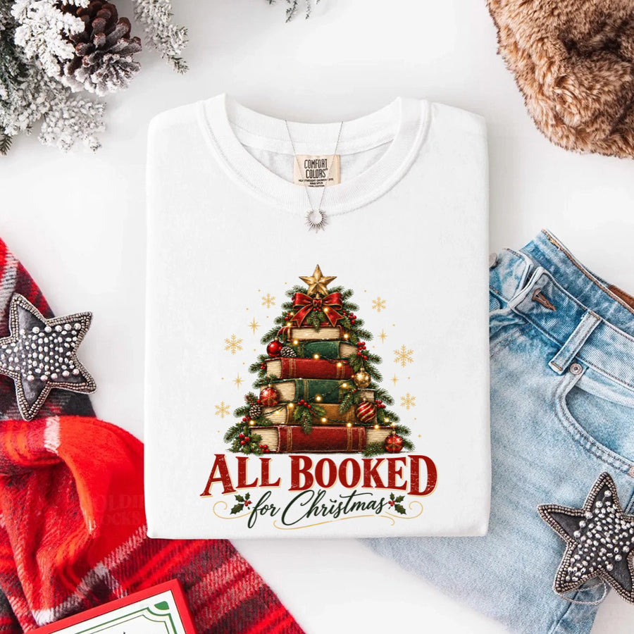May include an All Booked for Christmas Comfort Colors T-Shirt featuring a festive book lover statement design.