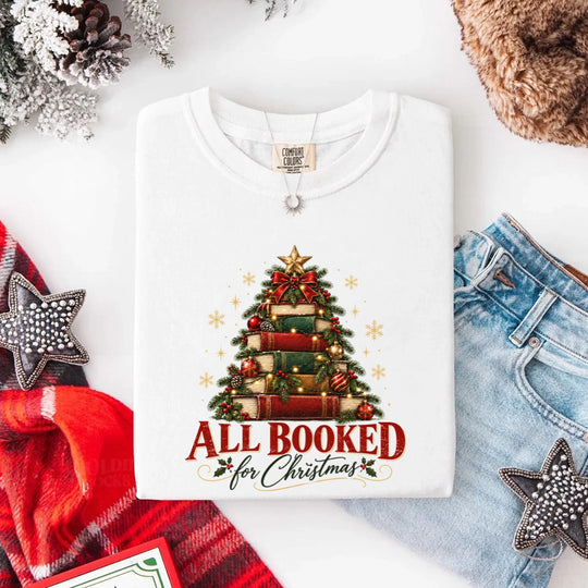 May include an All Booked for Christmas Comfort Colors T-Shirt featuring a festive book lover statement design.