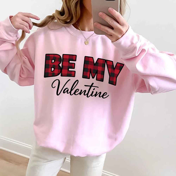 May include a buffalo plaid crewneck sweatshirt with Be My Valentine text printed on the front.