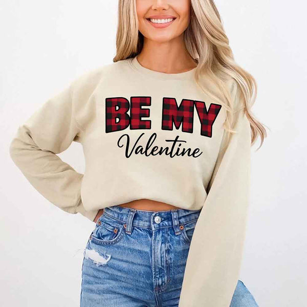May include a buffalo plaid crewneck sweatshirt with Be My Valentine text printed on the front.