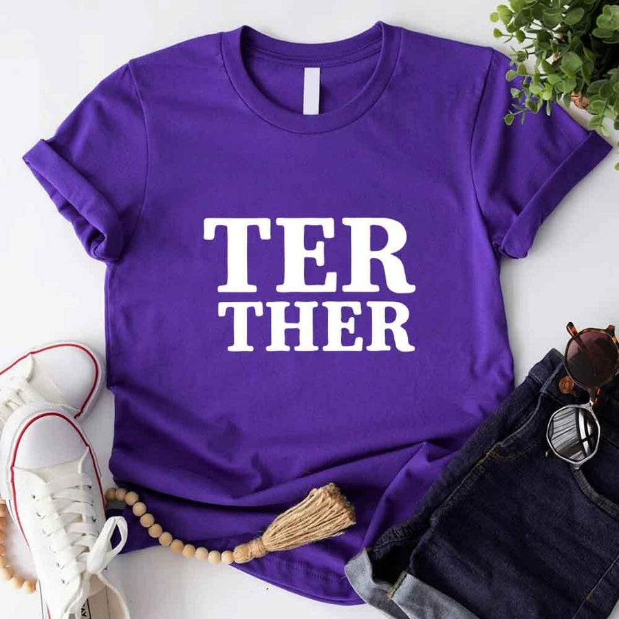 May include a “Better Together” couples T-shirt design with bold, friendly lettering arranged in a balanced layout, often paired with a small heart or link-style graphic that reflects unity and closeness.