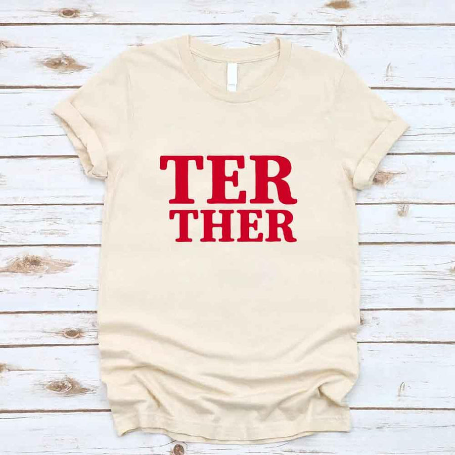 May include a “Better Together” couples T-shirt design with bold, friendly lettering arranged in a balanced layout, often paired with a small heart or link-style graphic that reflects unity and closeness.