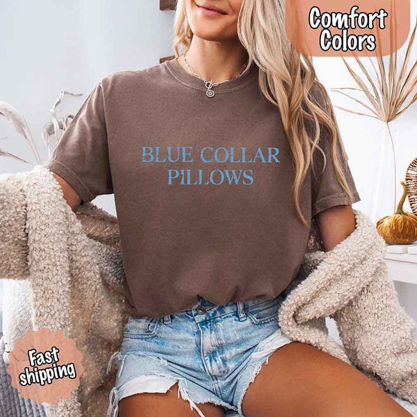 May include light blue distressed text that reads “Blue Collar Pillows,” using a simple serif font to evoke hardworking pride with a touch of rugged charm.