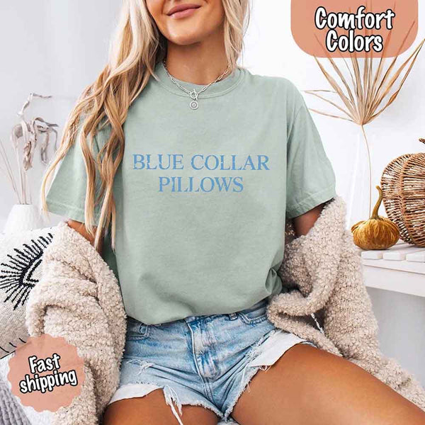 May include light blue distressed text that reads “Blue Collar Pillows,” using a simple serif font to evoke hardworking pride with a touch of rugged charm.