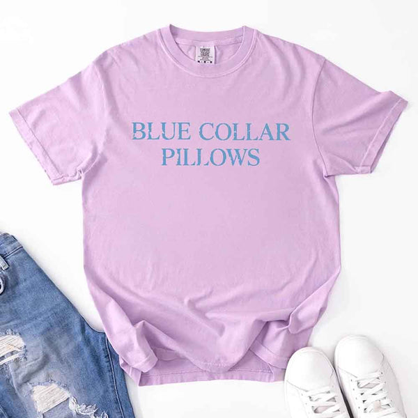 May include light blue distressed text that reads “Blue Collar Pillows,” using a simple serif font to evoke hardworking pride with a touch of rugged charm.