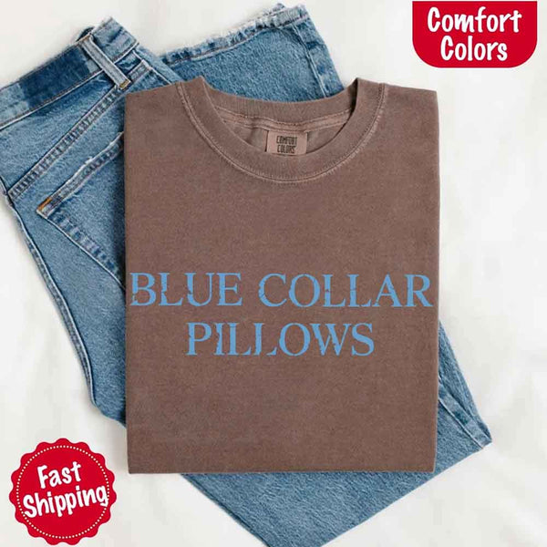 May include light blue distressed text that reads “Blue Collar Pillows,” using a simple serif font to evoke hardworking pride with a touch of rugged charm.