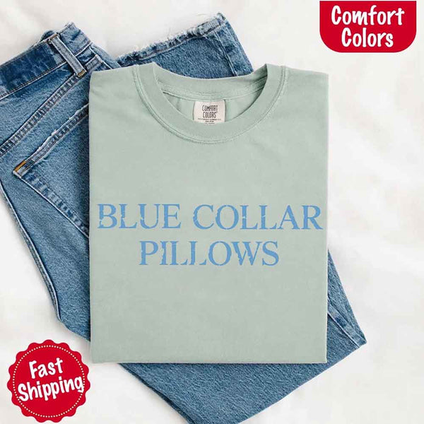 May include light blue distressed text that reads “Blue Collar Pillows,” using a simple serif font to evoke hardworking pride with a touch of rugged charm.