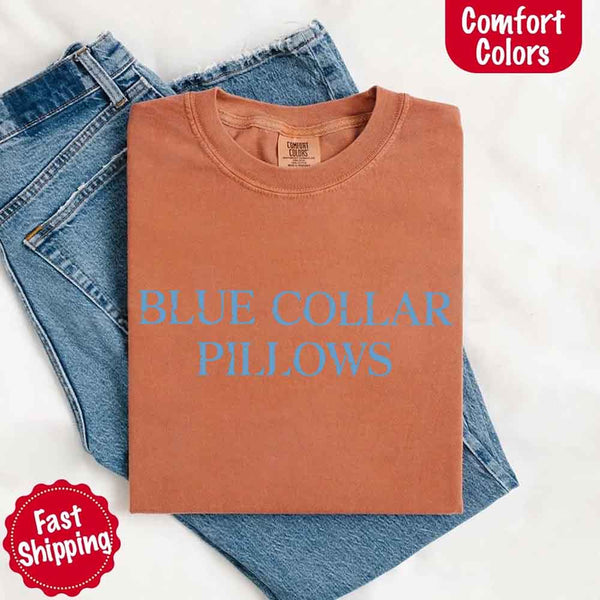 May include light blue distressed text that reads “Blue Collar Pillows,” using a simple serif font to evoke hardworking pride with a touch of rugged charm.