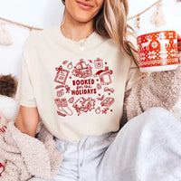 May include a Booked for the Holidays Comfort Colors T-Shirt featuring a festive Christmas and book-inspired statement design.