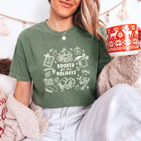 May include a Booked for the Holidays Comfort Colors T-Shirt featuring a festive Christmas and book-inspired statement design.
