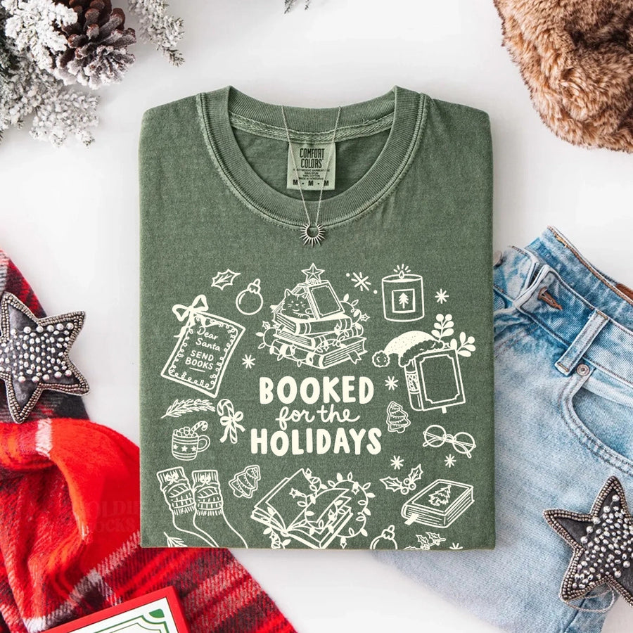 May include a Booked for the Holidays Comfort Colors T-Shirt featuring a festive Christmas and book-inspired statement design.