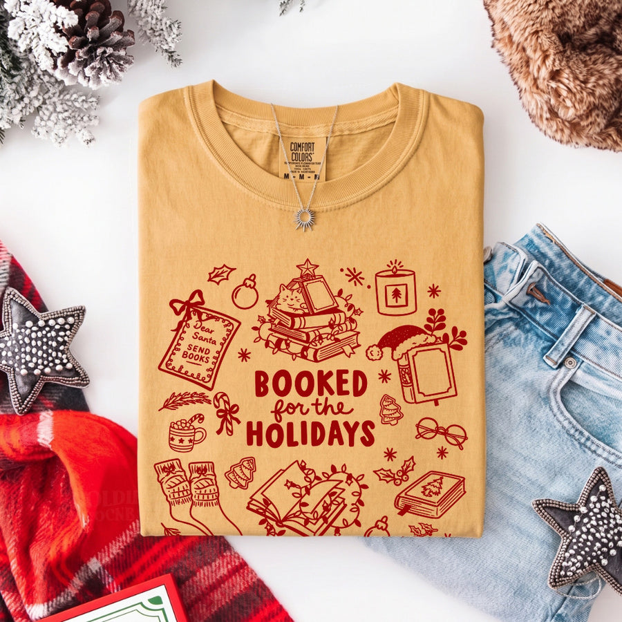 May include a Booked for the Holidays Comfort Colors T-Shirt featuring a festive Christmas and book-inspired statement design.