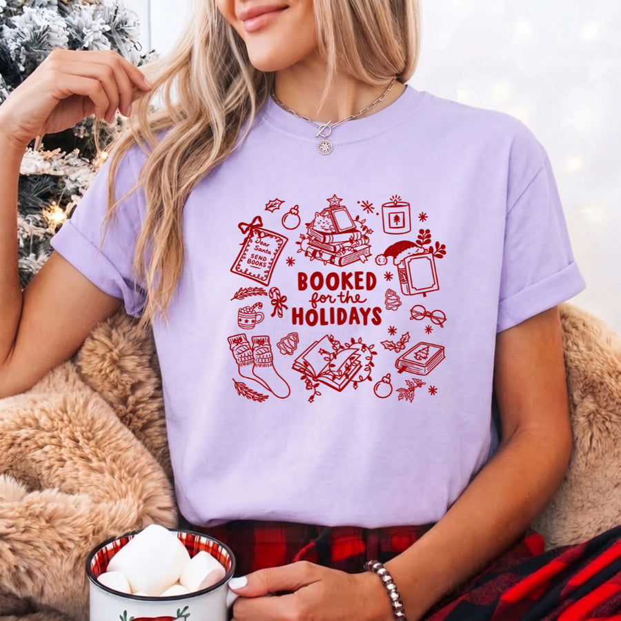 May include a Booked for the Holidays Comfort Colors T-Shirt featuring a festive Christmas and book-inspired statement design.