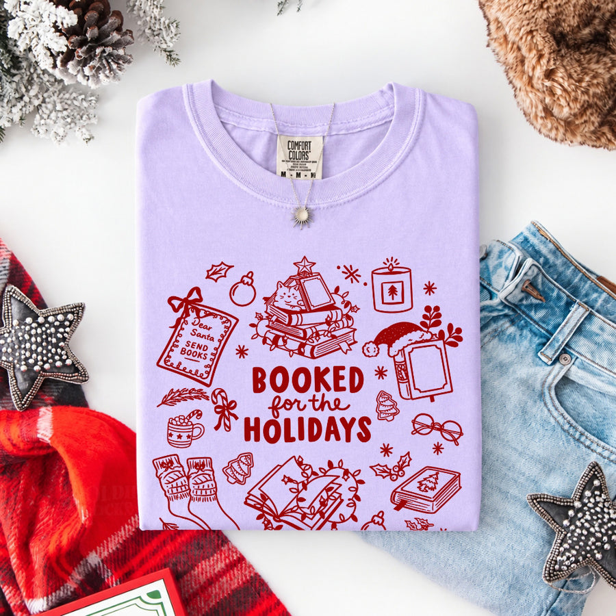May include a Booked for the Holidays Comfort Colors T-Shirt featuring a festive Christmas and book-inspired statement design.