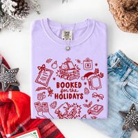 May include a Booked for the Holidays Comfort Colors T-Shirt featuring a festive Christmas and book-inspired statement design.
