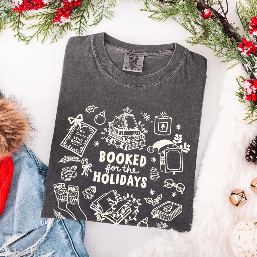 May include a Booked for the Holidays Comfort Colors T-Shirt featuring a festive Christmas and book-inspired statement design.