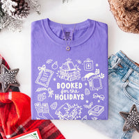 May include a Booked for the Holidays Comfort Colors T-Shirt featuring a festive Christmas and book-inspired statement design.
