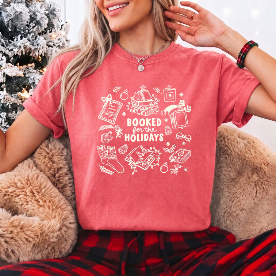 May include a Booked for the Holidays Comfort Colors T-Shirt featuring a festive Christmas and book-inspired statement design.