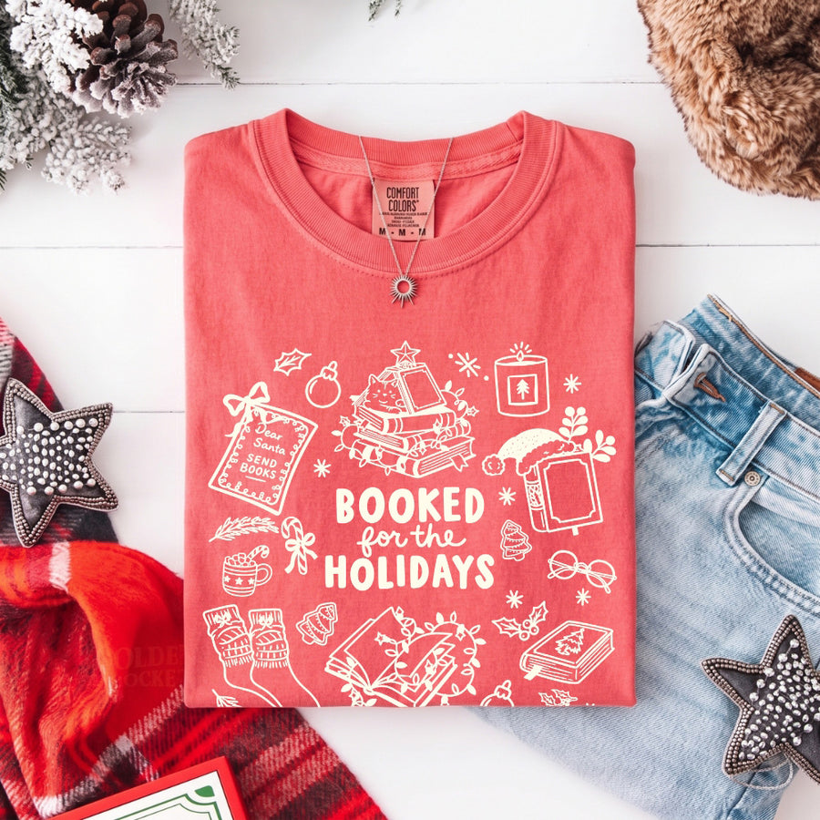 May include a Booked for the Holidays Comfort Colors T-Shirt featuring a festive Christmas and book-inspired statement design.