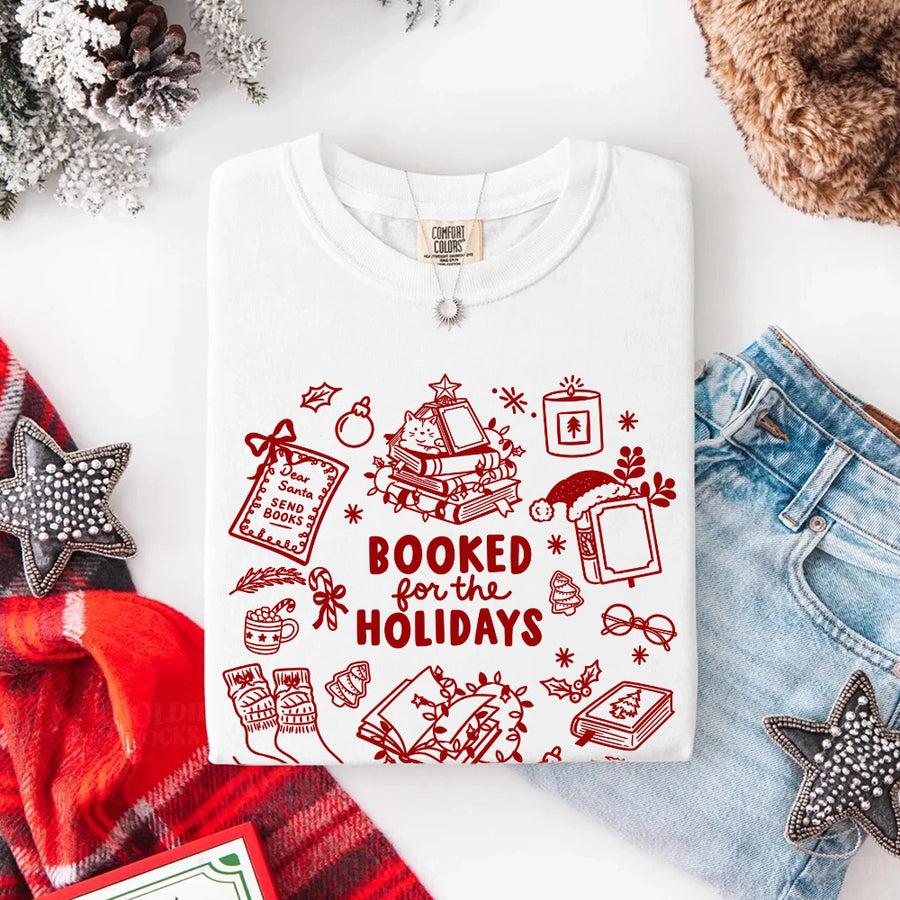 May include a Booked for the Holidays Comfort Colors T-Shirt featuring a festive Christmas and book-inspired statement design.