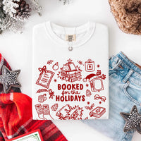 May include a Booked for the Holidays Comfort Colors T-Shirt featuring a festive Christmas and book-inspired statement design.