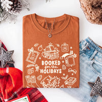 May include a Booked for the Holidays Comfort Colors T-Shirt featuring a festive Christmas and book-inspired statement design.