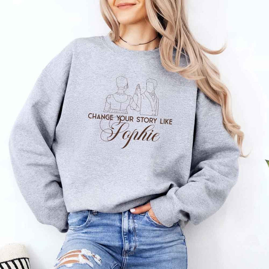 May include a person wearing a Grey Change Your Story Like Sophie Crewneck Sweatshirt featuring royal inspired graphic and classic fit.