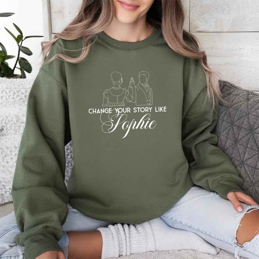 May include a person wearing a Military Green Change Your Story Like Sophie Crewneck Sweatshirt featuring royal inspired graphic and classic fit.