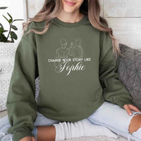 May include a person wearing a Military Green Change Your Story Like Sophie Crewneck Sweatshirt featuring royal inspired graphic and classic fit.
