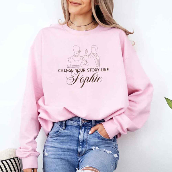 May include a person wearing a Pink Change Your Story Like Sophie Crewneck Sweatshirt featuring royal inspired graphic and classic fit.