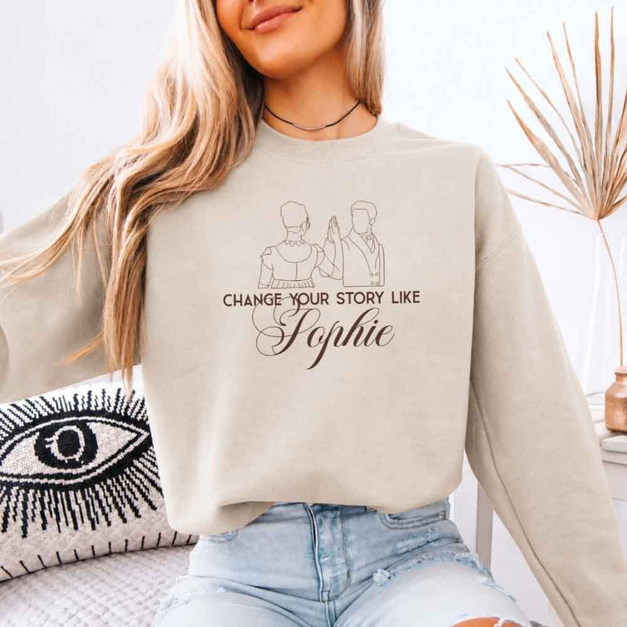 May include a person wearing a Sand Change Your Story Like Sophie Crewneck Sweatshirt featuring royal inspired graphic and classic fit.