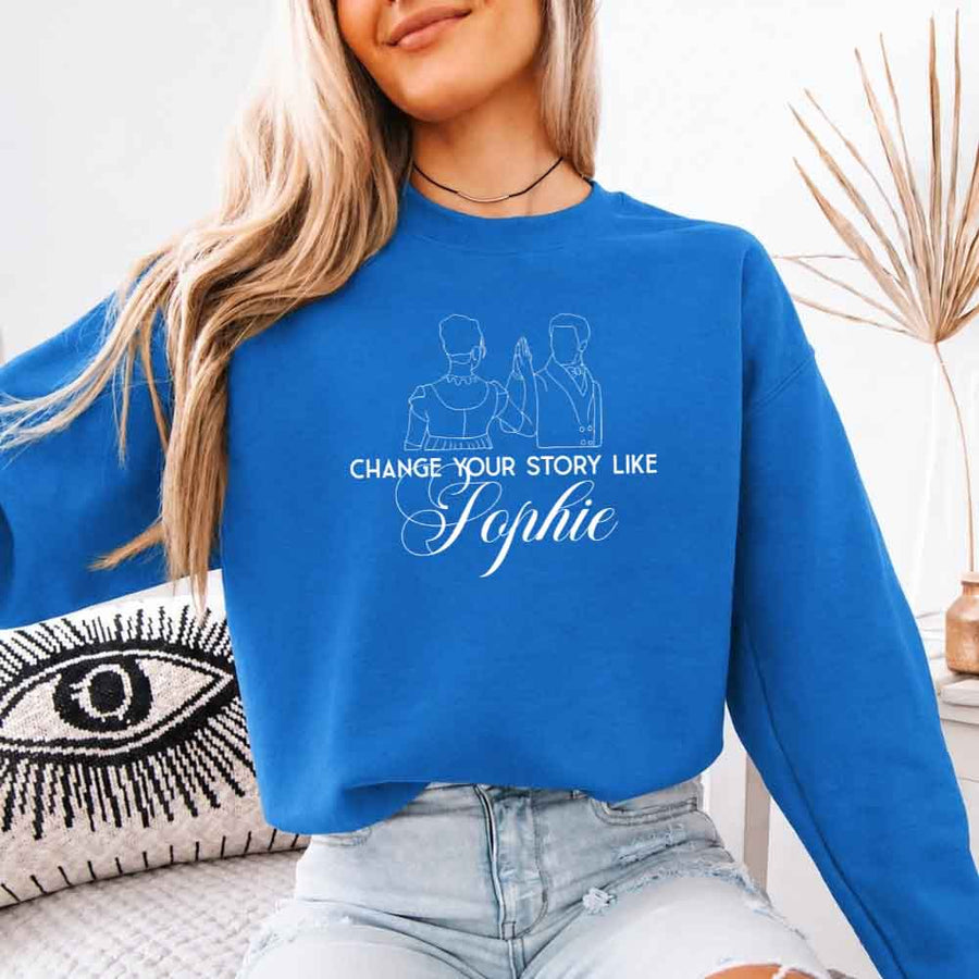 May include a person wearing a Sapphire Change Your Story Like Sophie Crewneck Sweatshirt featuring royal inspired graphic and classic fit.