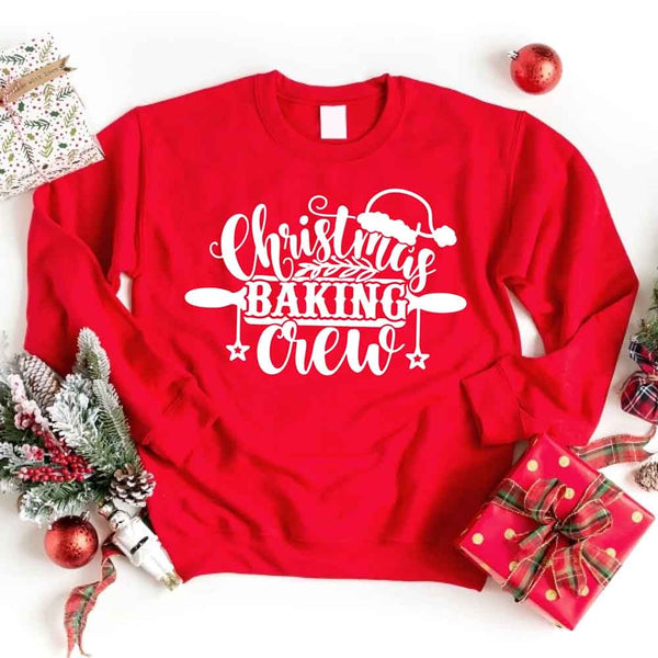 May include a festive t-shirt reading “Christmas Baking Crew” with cookie or whisk graphics, displayed flat or worn, ideal for holiday baking groups.