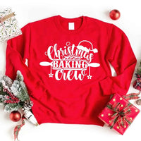 May include a festive t-shirt reading “Christmas Baking Crew” with cookie or whisk graphics, displayed flat or worn, ideal for holiday baking groups.