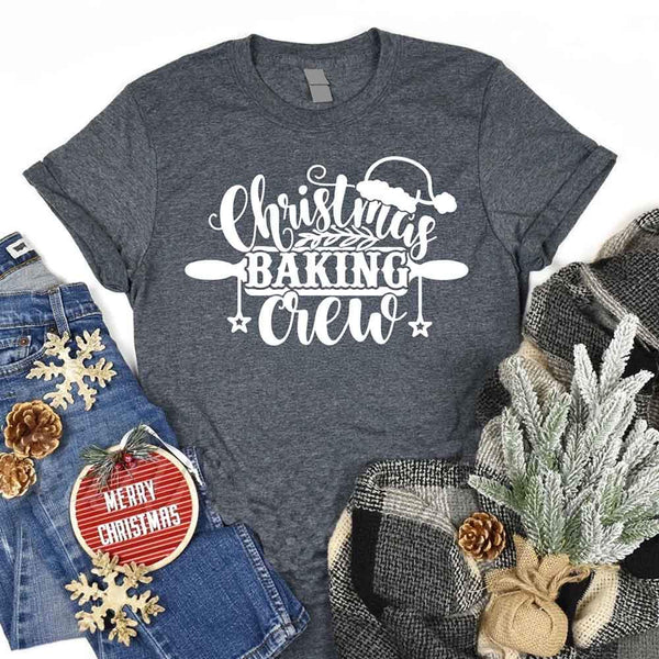 May include a festive t-shirt reading “Christmas Baking Crew” with cookie or whisk graphics, displayed flat or worn, ideal for holiday baking groups.