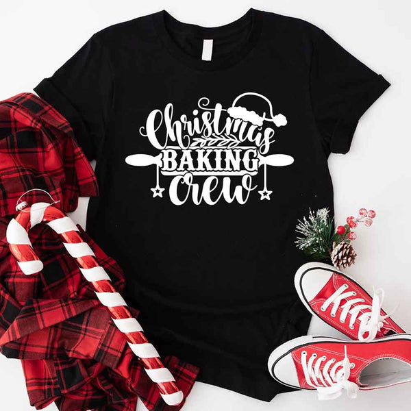 May include a festive t-shirt reading “Christmas Baking Crew” with cookie or whisk graphics, displayed flat or worn, ideal for holiday baking groups.