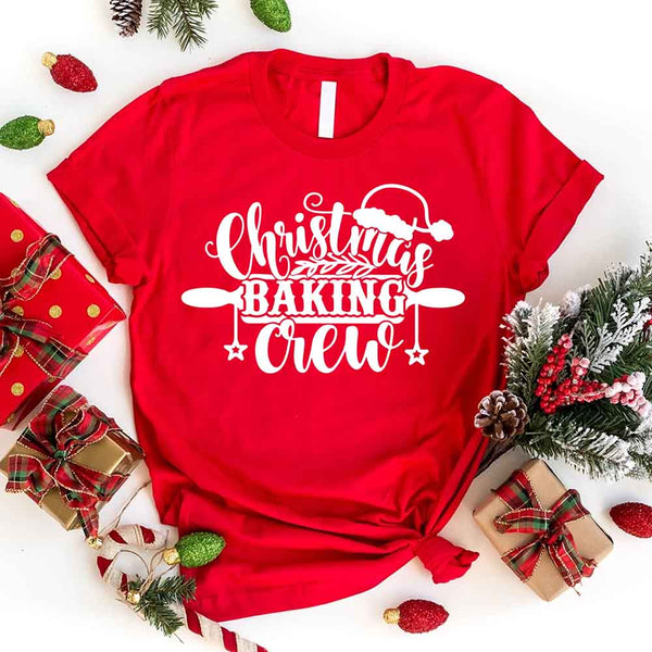 May include a festive t-shirt reading “Christmas Baking Crew” with cookie or whisk graphics, displayed flat or worn, ideal for holiday baking groups.
