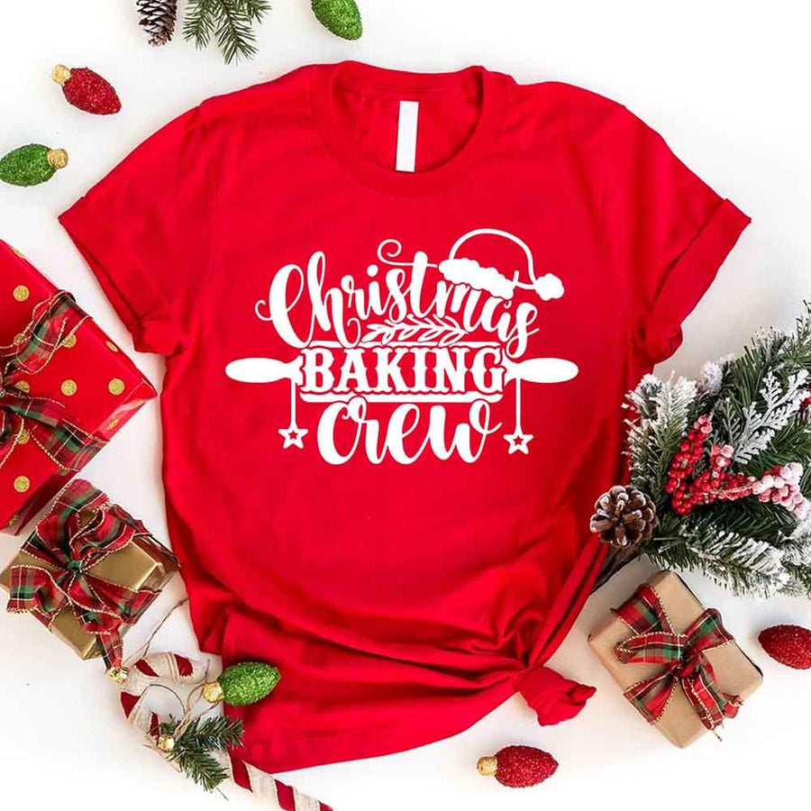 May include a festive t-shirt reading “Christmas Baking Crew” with cookie or whisk graphics, displayed flat or worn, ideal for holiday baking groups.