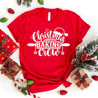 May include a festive t-shirt reading “Christmas Baking Crew” with cookie or whisk graphics, displayed flat or worn, ideal for holiday baking groups.