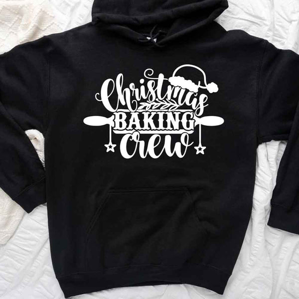 May include a festive t-shirt reading “Christmas Baking Crew” with cookie or whisk graphics, displayed flat or worn, ideal for holiday baking groups.