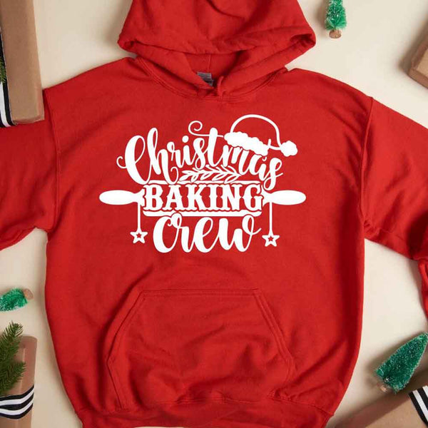 May include a festive t-shirt reading “Christmas Baking Crew” with cookie or whisk graphics, displayed flat or worn, ideal for holiday baking groups.