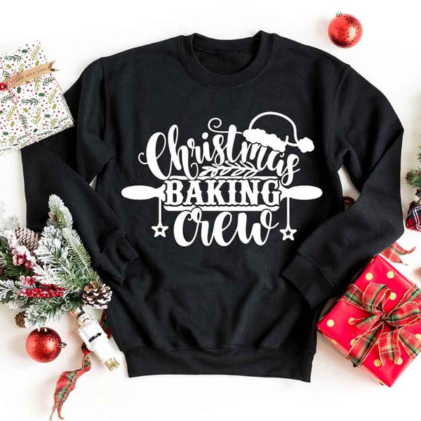 May include a festive t-shirt reading “Christmas Baking Crew” with cookie or whisk graphics, displayed flat or worn, ideal for holiday baking groups.