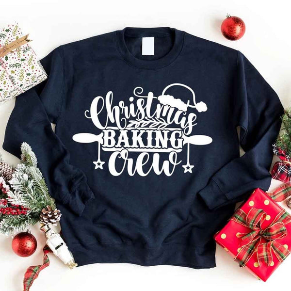 May include a festive t-shirt reading “Christmas Baking Crew” with cookie or whisk graphics, displayed flat or worn, ideal for holiday baking groups.